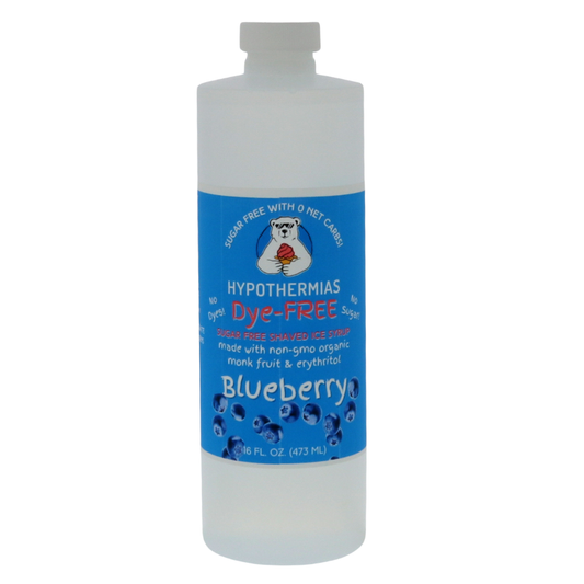 A pint of Hypothermias Sugar-Free & Dye-Free Blueberry Shaved Ice and Snow Cone Syrup in a BPA-free plastic bottle on a bright white background, featuring an azure blue label with blueberries representing the flavor. This clear, sugar-free shaved ice syrup is made with organic and non-GMO monk fruit and erythritol for a smooth, naturally sweet flavor without dyes or added sugars.