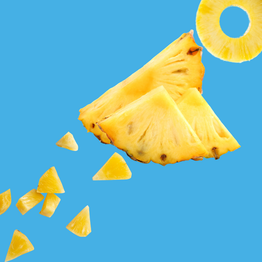 Fresh pineapple slices on a vibrant sky blue background representing Pineapple SUGAR FREE | Dye-FREE Shaved Ice & Snow Cone Syrup. Sweet tropical flavor, FREE & Clear, zero net carbs, sugar free, keto-friendly with organic non-GMO monk fruit & erythritol.