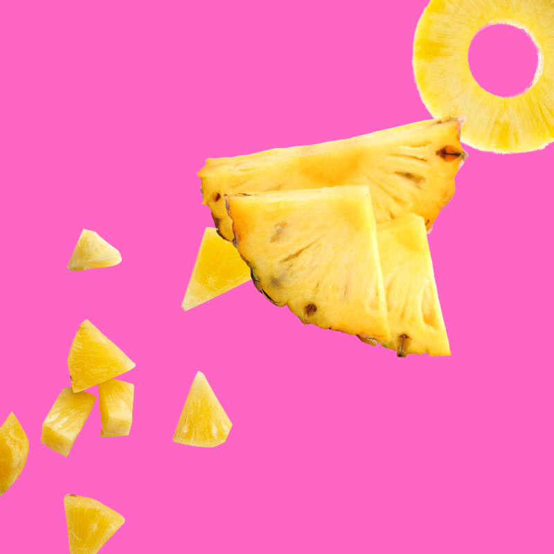Fresh pineapple slices on a vibrant pink background representing Hypothermias Pineapple Sugar Free Dye-FREE Slush Syrup, a keto-friendly tropical slush mix with zero net carbs for slush machines and frozen drinks
