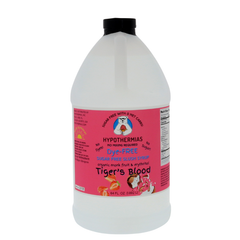 A half-gallon bottle of Hypothermias Sugar-Free & Dye-Free Tiger’s Blood Slush Syrup with a pink label featuring coconut, strawberry, and watermelon artwork, photographed on a white background. Crafted with organic monk fruit and erythritol for a tropical sugar-free slush flavor.