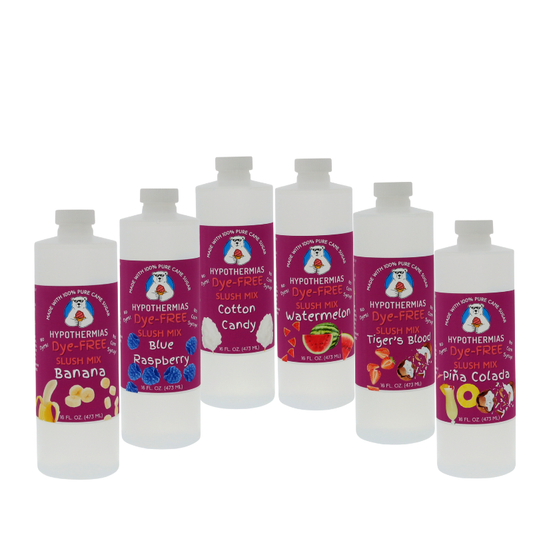 Picture of six BPA-free plastic bottles of Hypothermias Dye-FREE Slush Syrup on a white background. The flavors shown are Banana, Blue Raspberry, Cotton Candy, Watermelon, Tiger’s Blood, and Pina Colada. Each pint bottle features a purple label with fruit imagery for its flavor. Clear, dye-free syrup made with non-GMO 100% pure cane sugar. A gourmet slush mix and frozen drink syrup, small-batch crafted under the Tucson sun in Arizona, USA.