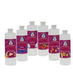 Picture of six BPA-free plastic bottles of Hypothermias Dye-FREE Slush Syrup on a white background. The flavors shown are Banana, Blue Raspberry, Cotton Candy, Watermelon, Tiger’s Blood, and Pina Colada. Each pint bottle features a purple label with fruit imagery for its flavor. Clear, dye-free syrup made with non-GMO 100% pure cane sugar. A gourmet slush mix and frozen drink syrup, small-batch crafted under the Tucson sun in Arizona, USA.