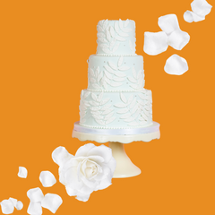 Wedding cake on a burnt orange background representing Wild Desert Dye-FREE Wedding Cake Coffee Syrup, made with non-GMO 100% pure cane sugar. Small-batch crafted by a family-owned business, this syrup is dye-free, indulgent, and perfect for coffee, lattes, teas, smoothies, and specialty drinks.