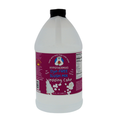A BPA-free plastic half-gallon bottle of Hypothermias Dye-FREE Wedding Cake Slush Syrup with a vibrant purple label featuring a white wedding cake, photographed on a clean white background. This clear, gourmet frozen drink syrup is crafted in small batches in Tucson, Arizona, with non-GMO 100% pure cane sugar and no high fructose corn syrup. Delivers smooth vanilla-almond flavor for slushie machines and dessert beverages.