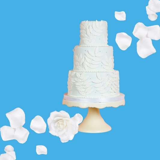 White wedding cake slices on a vibrant sky blue background representing Hypothermias Wedding Cake SUGAR FREE | Dye-FREE Shaved Ice Syrup. Sweet indulgent cake flavor, FREE & Clear, sugar free, dye free, keto-friendly with monk fruit & erythritol.