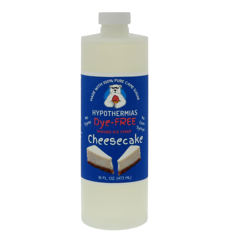 A pint of Hypothermias Dye-FREE Cheesecake Shaved Ice Syrup in a BPA-free plastic bottle on a clean white background, featuring a dark blue label with an image of cheesecake to represent the flavor. The syrup is clear and contains no dyes, made from non-GMO 100% pure cane sugar by a family-run small business proudly crafted under the Tucson sun in Arizona, USA.