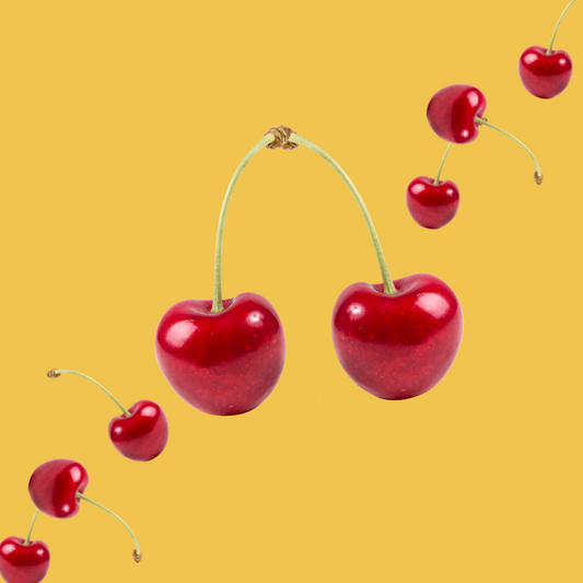 Fresh cherries on a golden yellow background representing Wild Desert Sugar Free Dye-FREE Cherry Coffee Syrup. Crafted with organic monk fruit and organic non-GMO erythritol by a family-owned business in Tucson, Arizona. Clear pour, dye-free, sugar-free syrup with bold cherry flavor—perfect for coffee, lattes, teas, smoothies, desserts, and specialty drinks. Keto-friendly, low-carb, and made in small batches for gourmet quality.