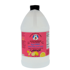 A half-gallon bottle of Hypothermias Sugar-Free & Dye-Free Lemon Slush Syrup with a pink label featuring bright yellow lemons, displayed on a white background. Made in Tucson, Arizona, with organic monk fruit and erythritol for a clear, tangy sugar-free slush flavor.