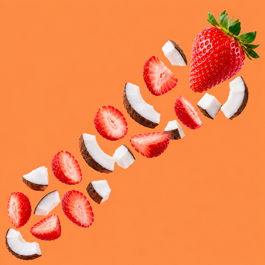 Fresh strawberries and coconut pieces floating on an orange background, representing Hypothermias Natural Tiger's Blood Flavor Concentrate for snow cones and shaved ice.