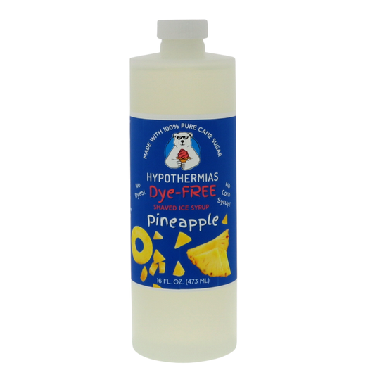 A pint of Hypothermias Dye-FREE Pineapple Shaved Ice & Snow Cone Syrup in a BPA-free plastic bottle on a bright white background, featuring a dark blue label with an image of fresh pineapple slices representing the flavor. The syrup is clear with no dyes and made from pure cane sugar and non-GMO ingredients by a family-run small business in Tucson, Arizona, USA — a UNESCO City of Gastronomy.