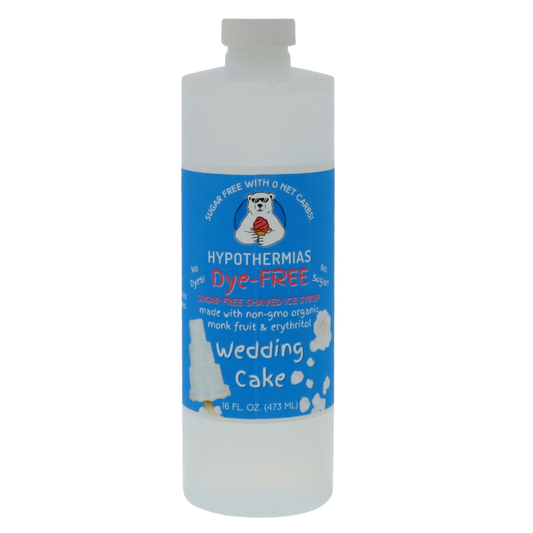 A pint of Hypothermias Sugar Free & Dye-Free Wedding Cake Shaved Ice and Snow Cone Syrup in a BPA-free plastic bottle on a bright white background, featuring an azure blue label with a wedding cake illustration. This clear, sugar-free syrup is made with organic and non-GMO monk fruit and erythritol for a smooth, vanilla-almond flavor without dyes or added sugars.